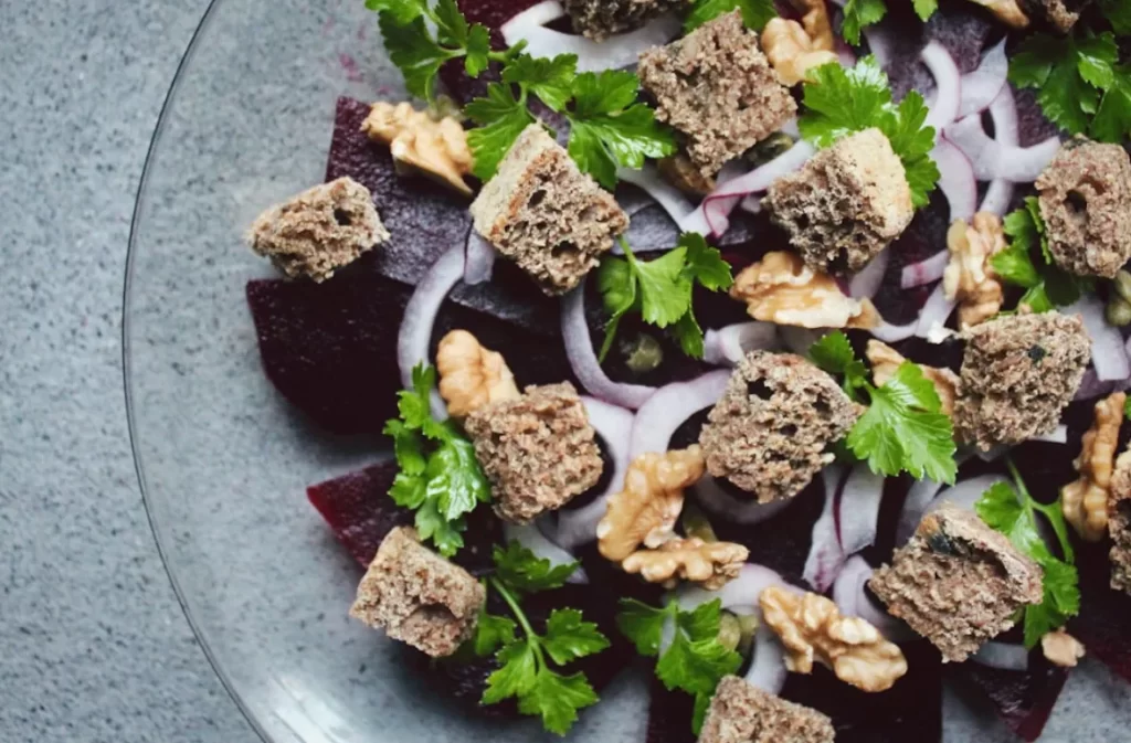 Beet salad with walnuts, parsley, and croutons.