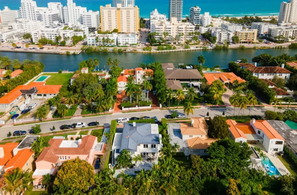 Urban coastal neighborhood with palm trees and waterways.
