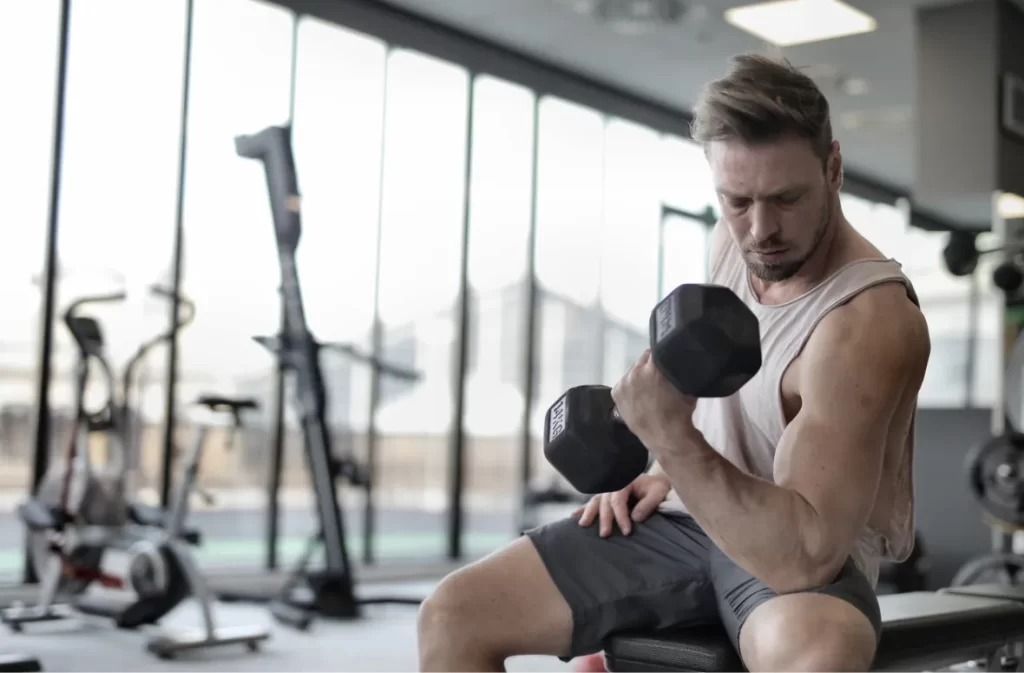 Man lifting a dumbbell during a focused workout session