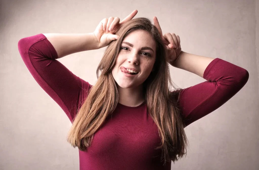 Woman making a playful face as a lesson in being funnier.