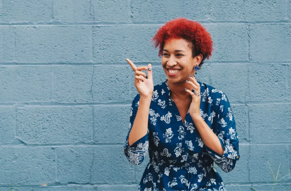 Smiling woman pointing, a moment of joy and humor.