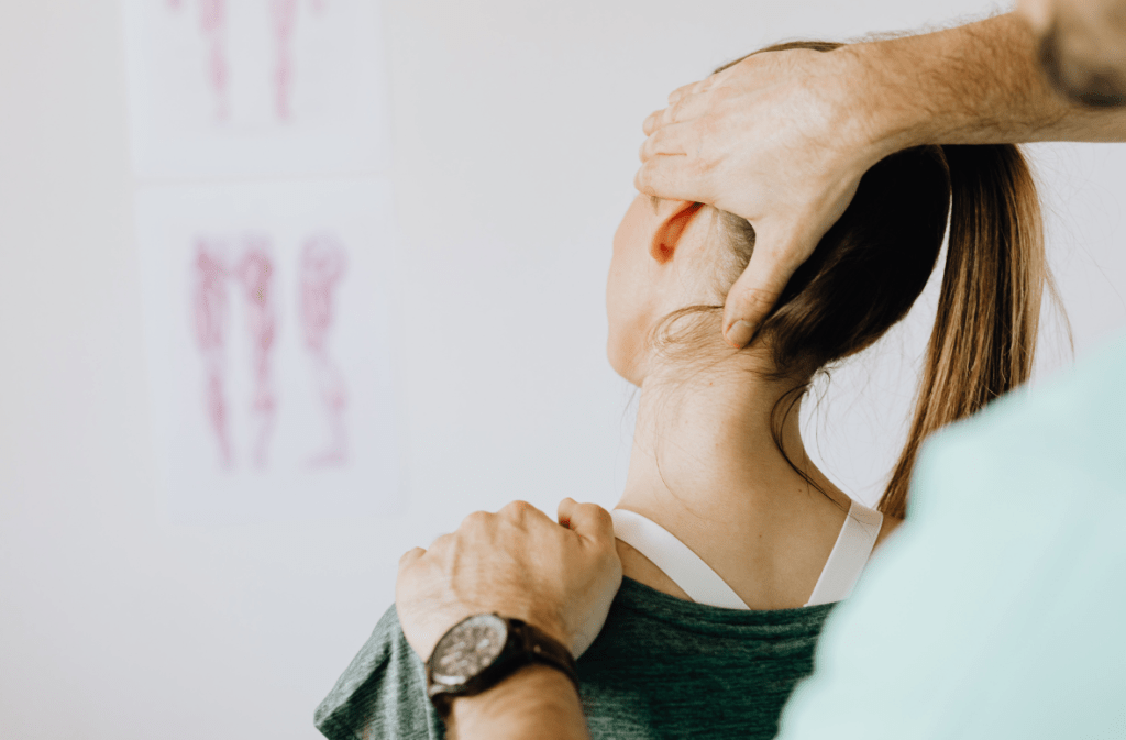 Chiropractor adjusting the back of a woman's neck.