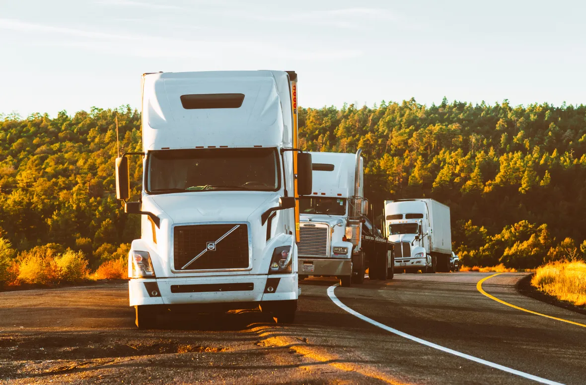 Trucks on the highway representing road transportation.